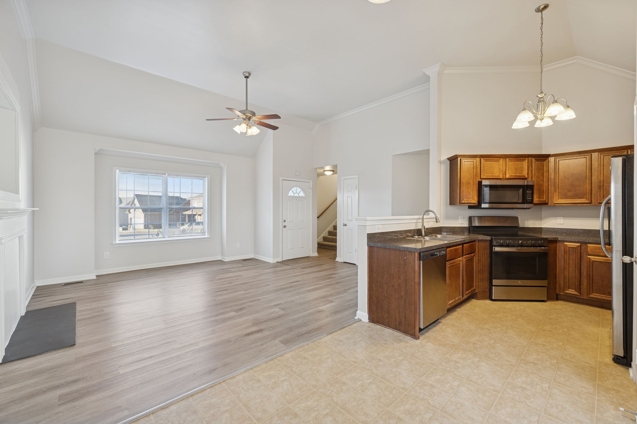8010 Tiger Court Spring Hill, TN 37174 - Photo 9 of 36 a kitchen with stove cabinets and refrigerator