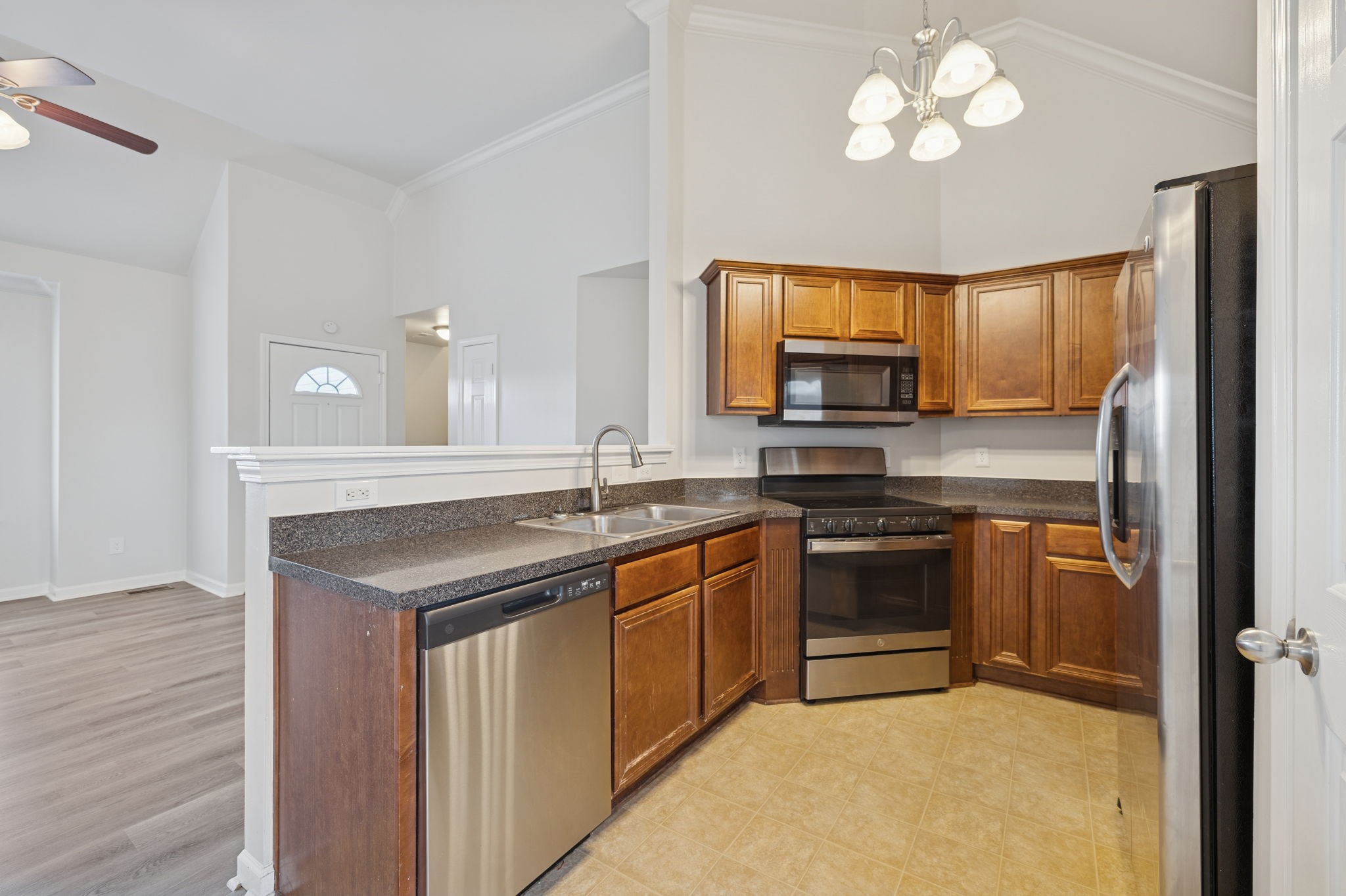 8010 Tiger Court Spring Hill, TN 37174 - Photo 10 of 36 a kitchen with a stove and a microwave