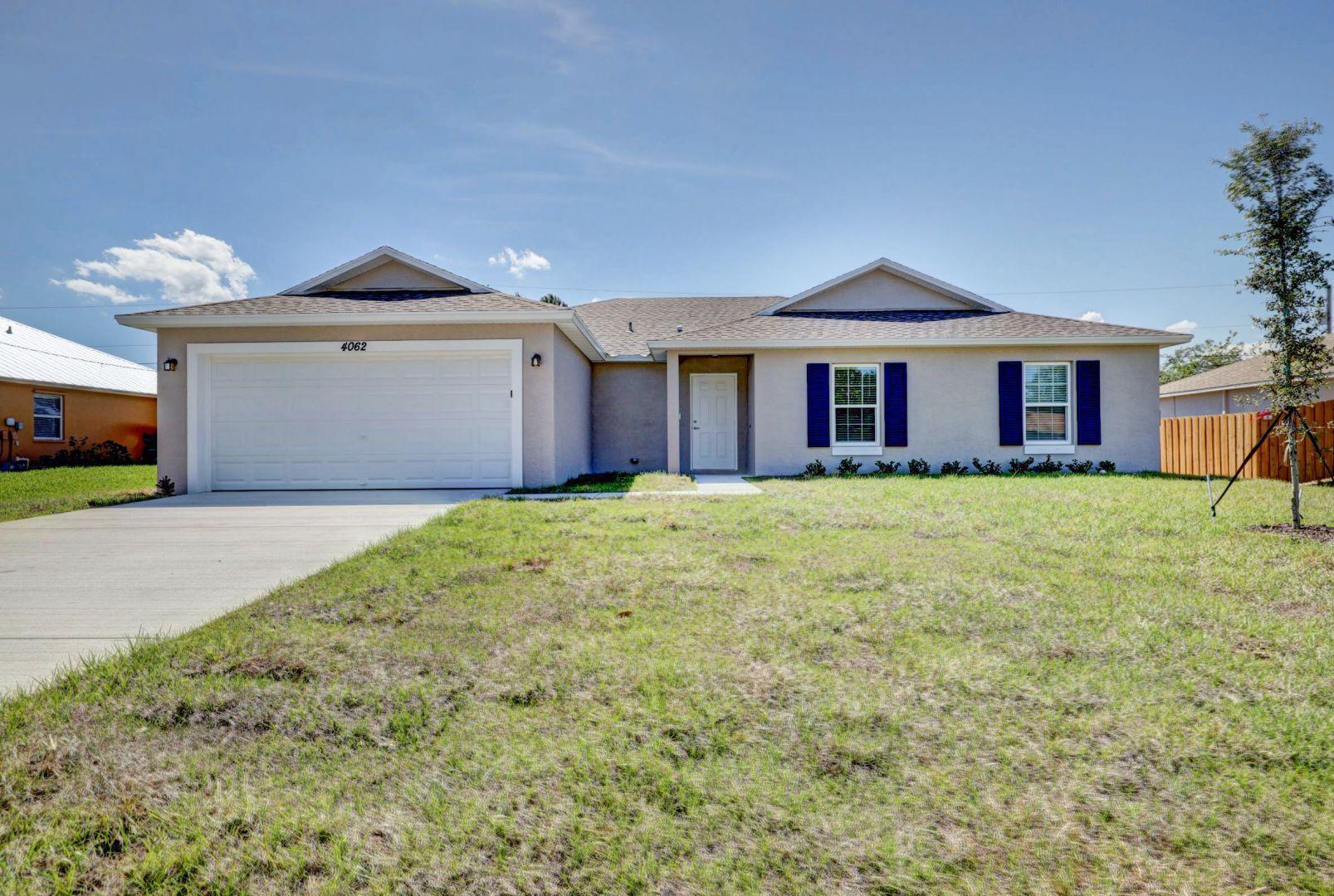 a front view of house with yard and garage