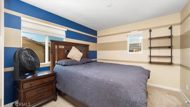 a bedroom with a bed and window