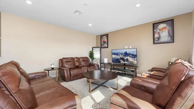 a living room with furniture a couch and a flat screen tv
