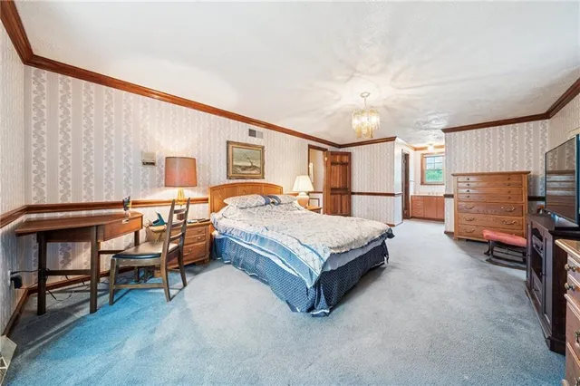 a bedroom with a bed and a dresser in it