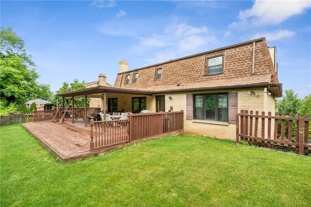 a view of a house with a backyard and porch