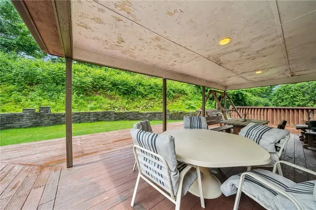 a view of a patio with a table chairs and a floor to ceiling window