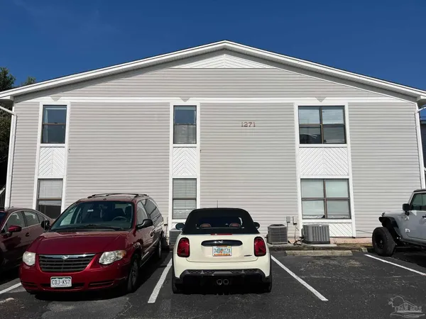 a white car parked in front of a house