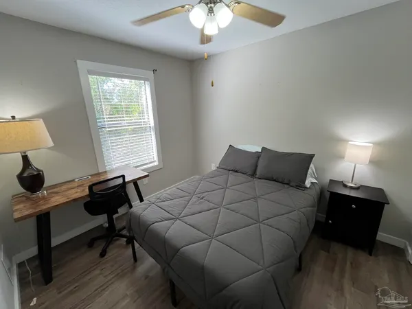 a bedroom with a bed and a window