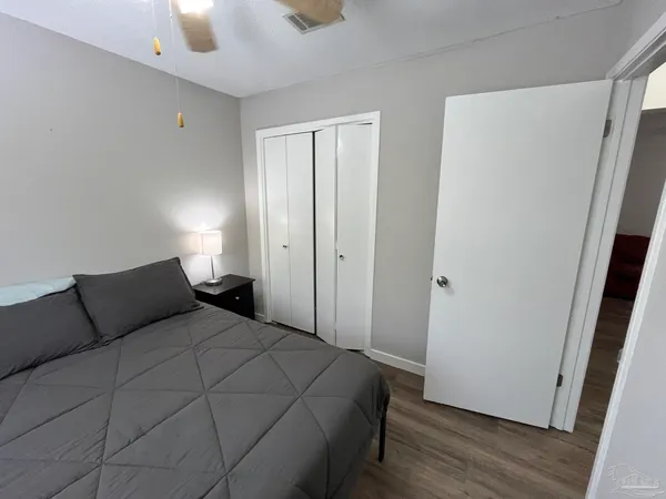 a bedroom with a bed and wooden floor