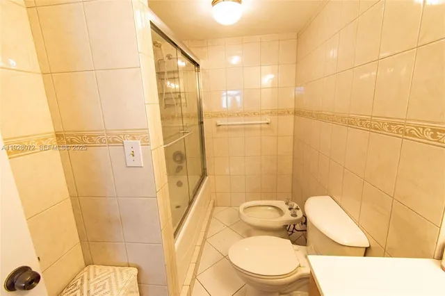a bathroom with a toilet sink and shower