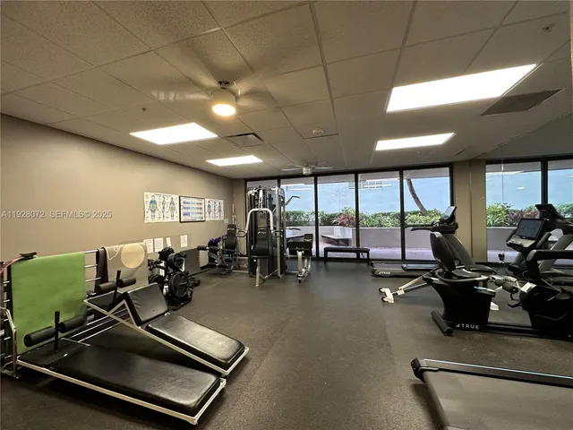 a room with gym equipment and large mirror