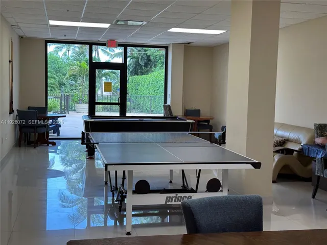 a living room with furniture and large windows