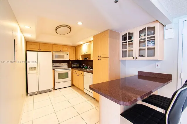 a kitchen with stainless steel appliances kitchen island granite countertop a stove and a refrigerator