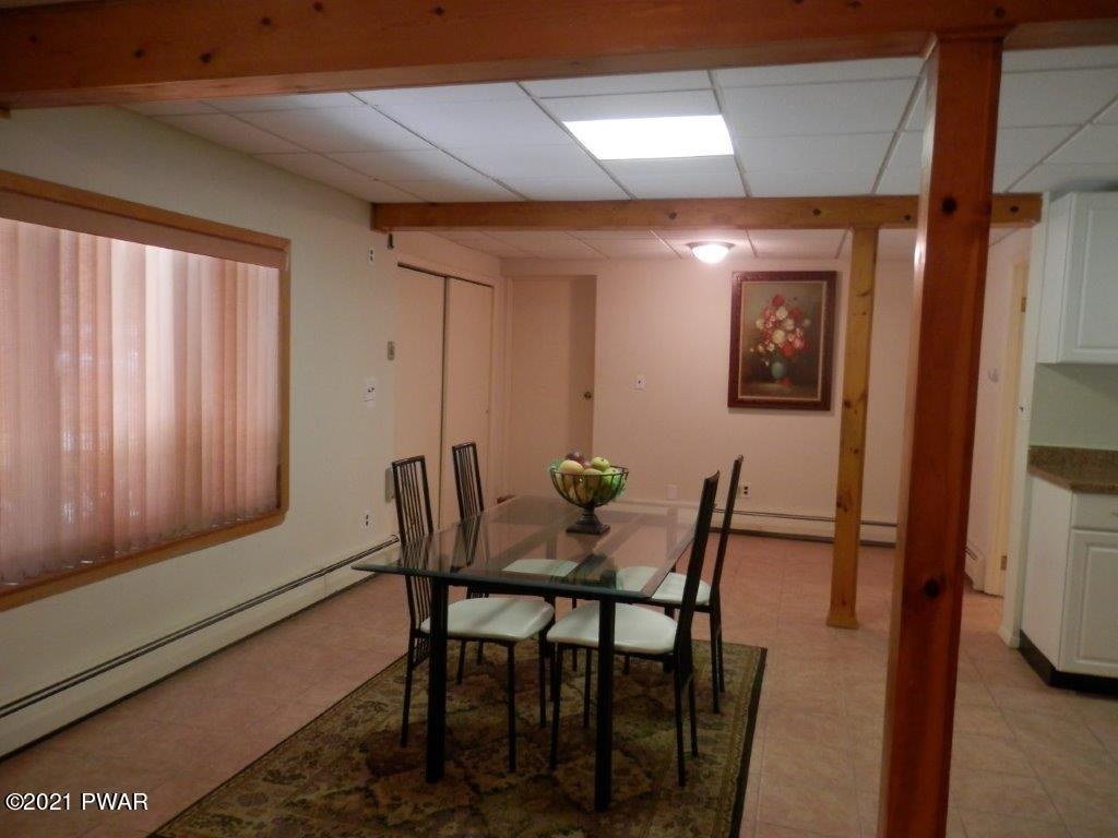 112 Squirrel Road Dingmans Ferry, PA 18328 - Photo 16 of 26 a view of a dining room with furniture and wooden floor