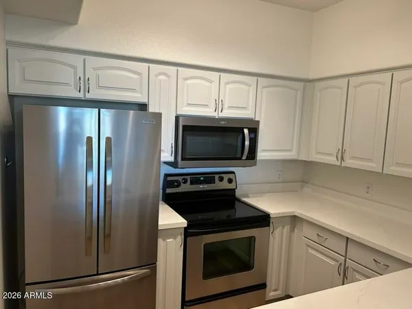 a view of kitchen and wooden floor