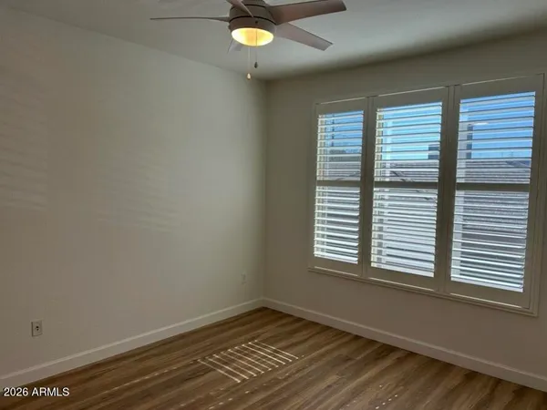 a kitchen with white cabinets and sink