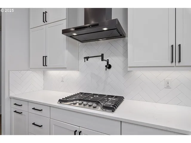 a stove top oven sitting inside of a kitchen