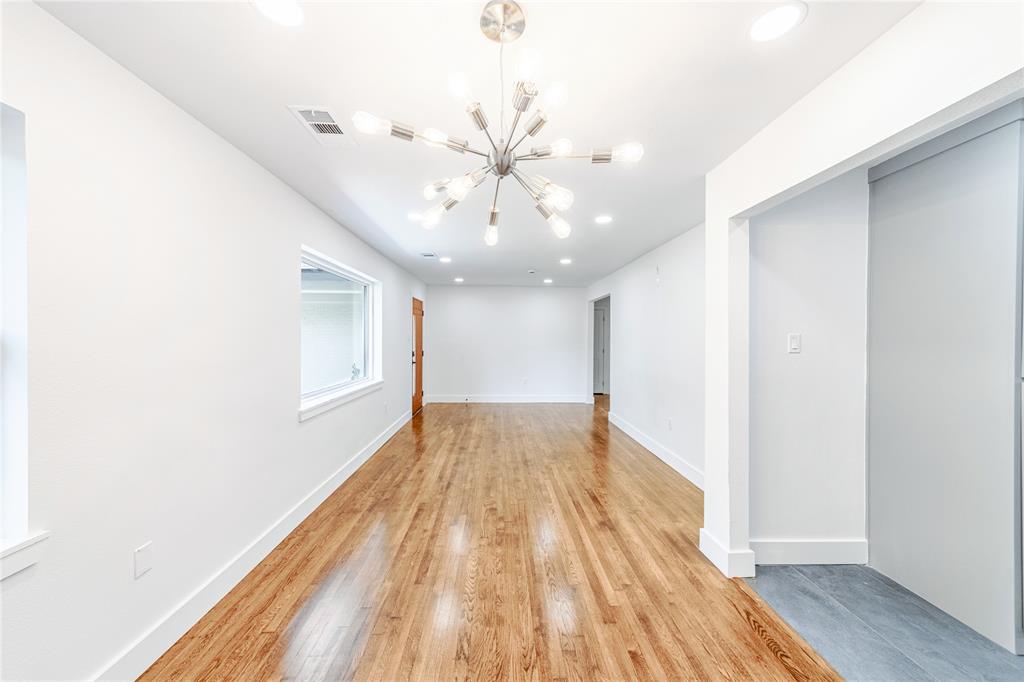 932 Treasure Road Garland, TX 75041 - Photo 5 of 28 Spare room featuring light wood finished floors, a chandelier, and recessed lighting