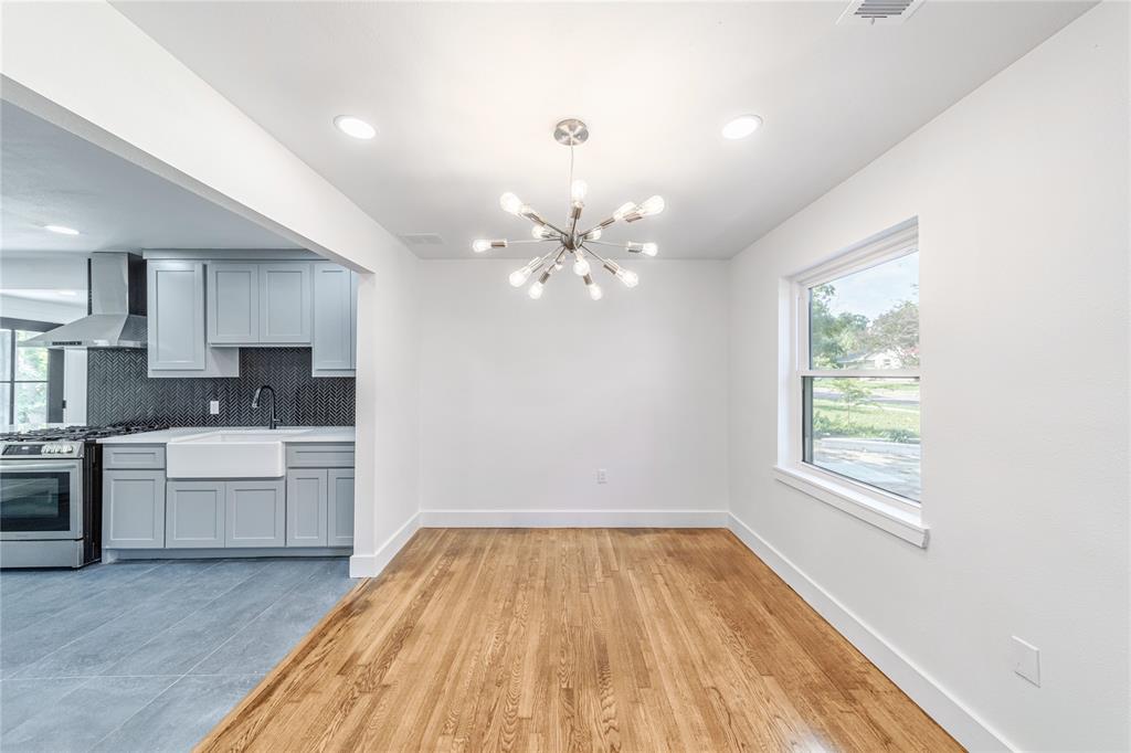 932 Treasure Road Garland, TX 75041 - Photo 6 of 28 Unfurnished dining area featuring a chandelier, light wood-style floors, and recessed lighting