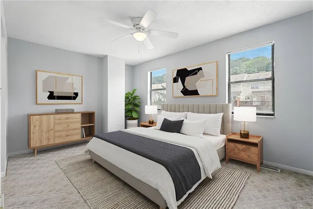 a bedroom with a bed a mirror on dresser and a window