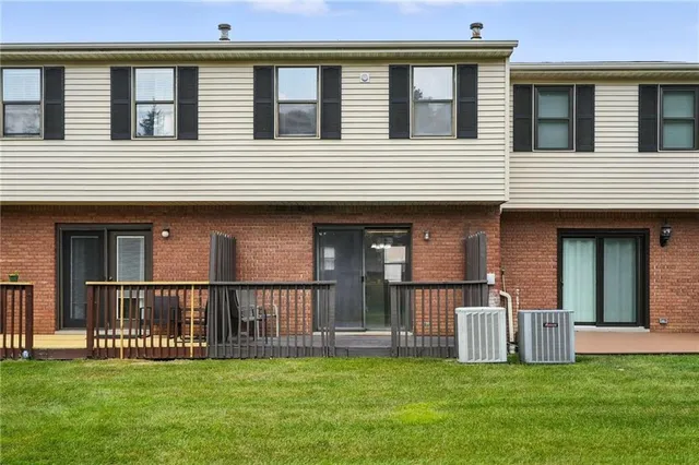 a view of a house with a yard and a large window
