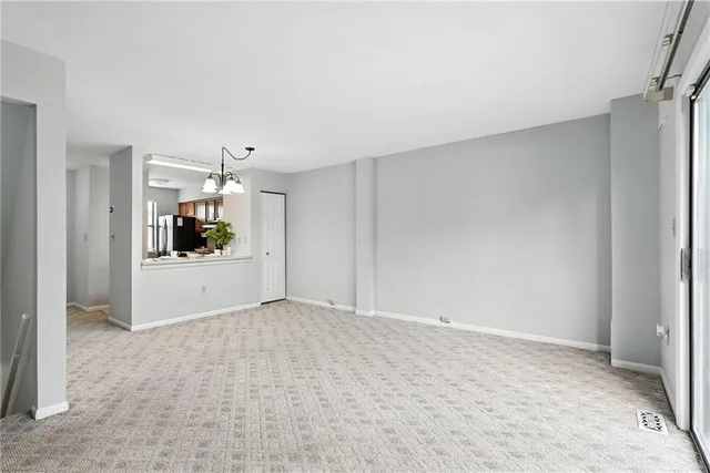 a view of a kitchen with white cabinets and wooden floor