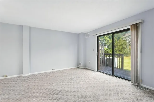 a view of an empty room with glass door