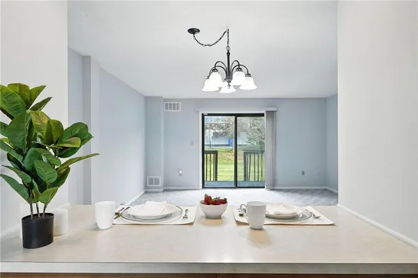 a living room with furniture potted plant and a window