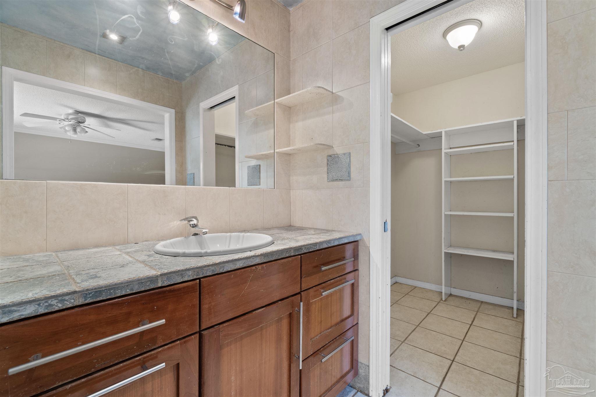 1151 Stone Bridge Road Pensacola, FL 32514 - Photo 26 of 52 a bathroom with a granite countertop sink and a mirror