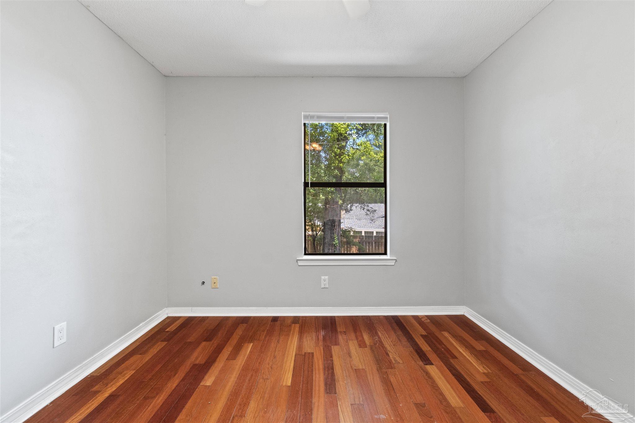 1151 Stone Bridge Road Pensacola, FL 32514 - Photo 28 of 52 a view of an empty room with wooden floor and a window