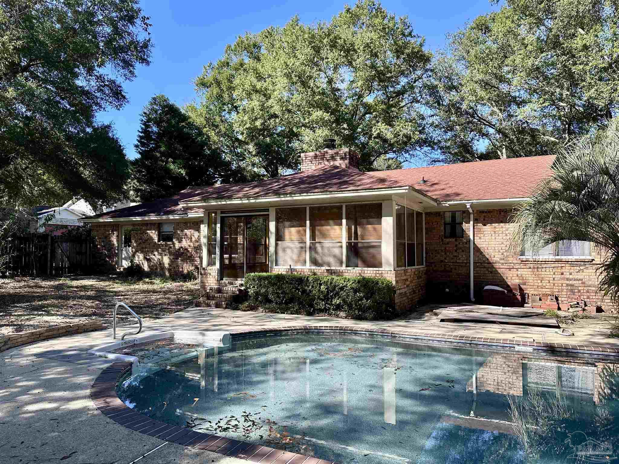 1151 Stone Bridge Road Pensacola, FL 32514 - Photo 6 of 52 a front view of a house with garden