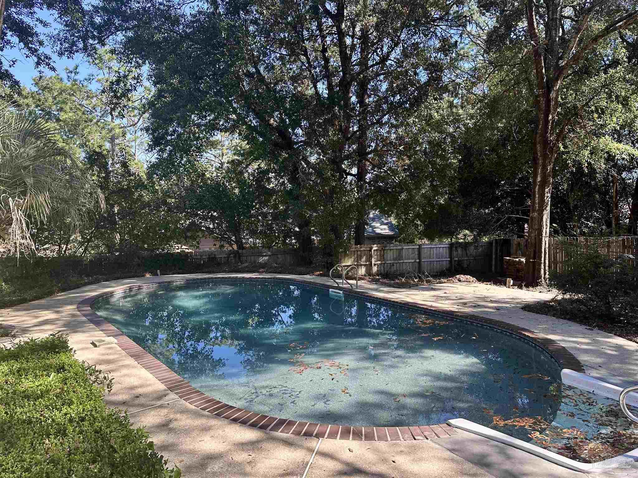 1151 Stone Bridge Road Pensacola, FL 32514 - Photo 7 of 52 a view of a swimming pool with a yard