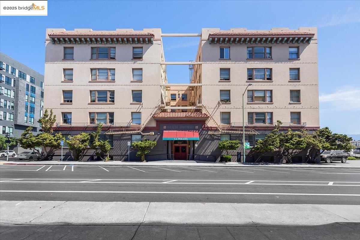 184 13th Street Oakland, CA 94612 - Photo 3 of 17 a front view of multi story residential apartment building with yard