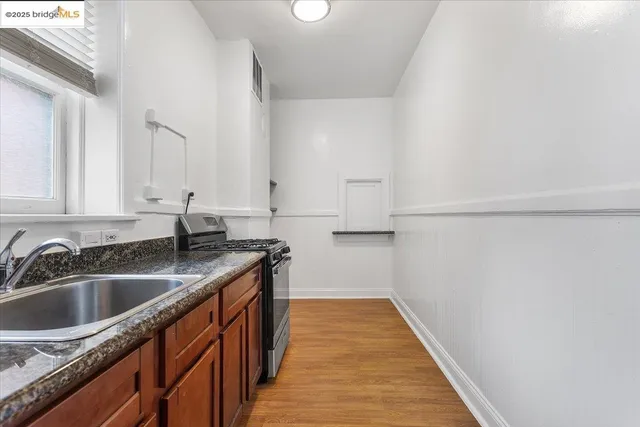 a kitchen with sink cabinets and wooden floor