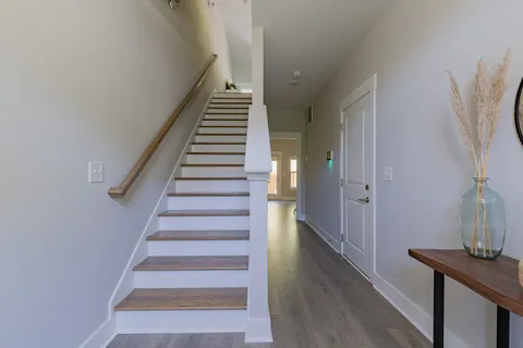 a view of entryway and hall with wooden floor