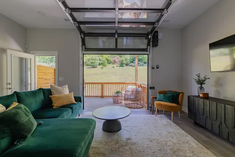 a living room with furniture and a floor to ceiling window