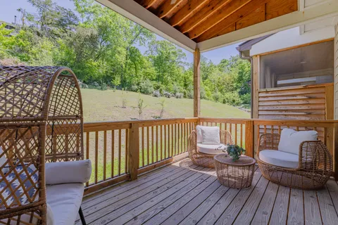 a view of balcony with wooden floor and outdoor seating