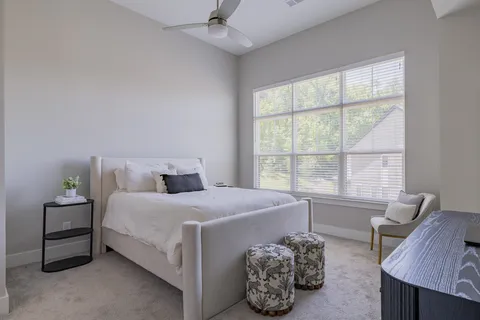 a bedroom with a bed and a window