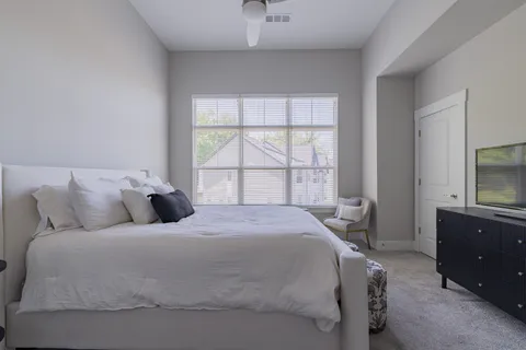 a bedroom with a bed and a television