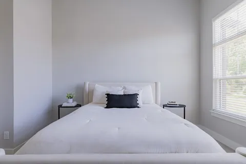 a bedroom with a bed and window