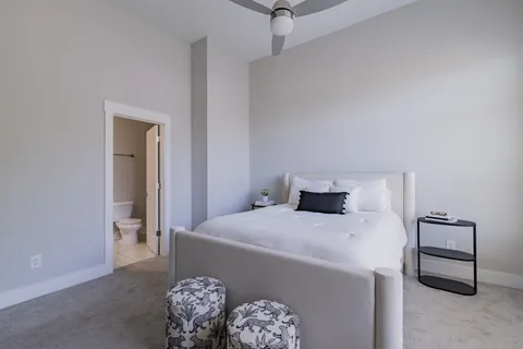 a bedroom with a bed and a table