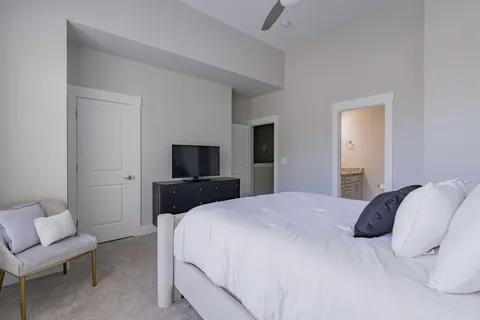 a bedroom with a bed and a chair