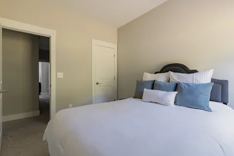 a bedroom with a bed and a closet