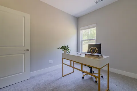 a view of a workspace with furniture