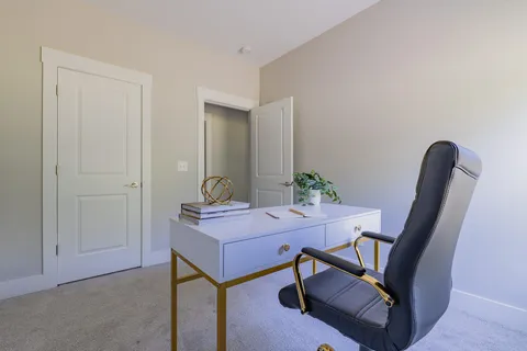 a view of a workspace with furniture and wooden floor