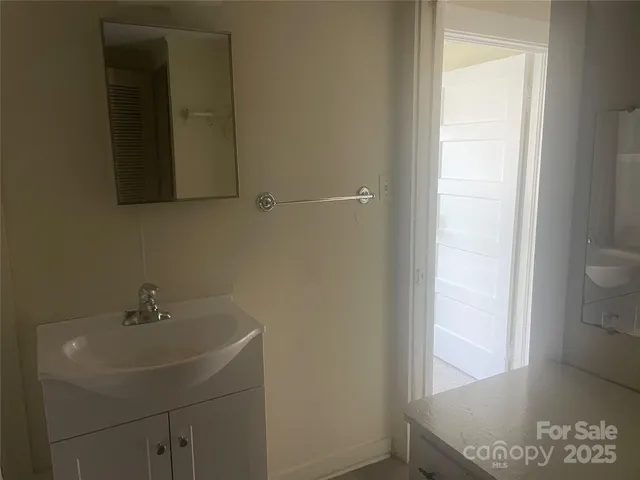 a bathroom with a granite countertop shower and a sink