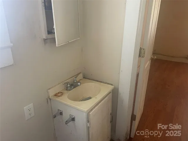 a kitchen with a refrigerator and a sink