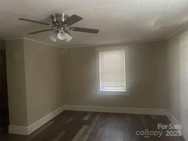 a view of a room with wooden floor and fan