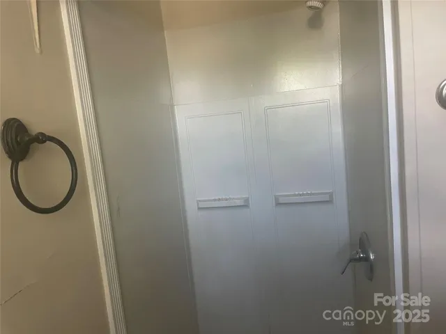 a view of a house with a door and wooden fence