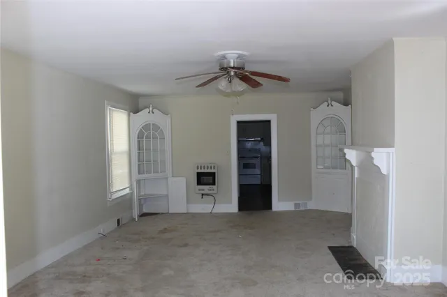 a kitchen with stainless steel appliances white cabinets and a refrigerator
