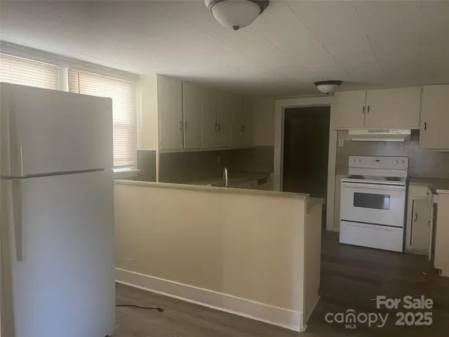 a kitchen with stainless steel appliances a refrigerator and a stove top oven