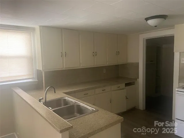 a kitchen with a stove and a refrigerator